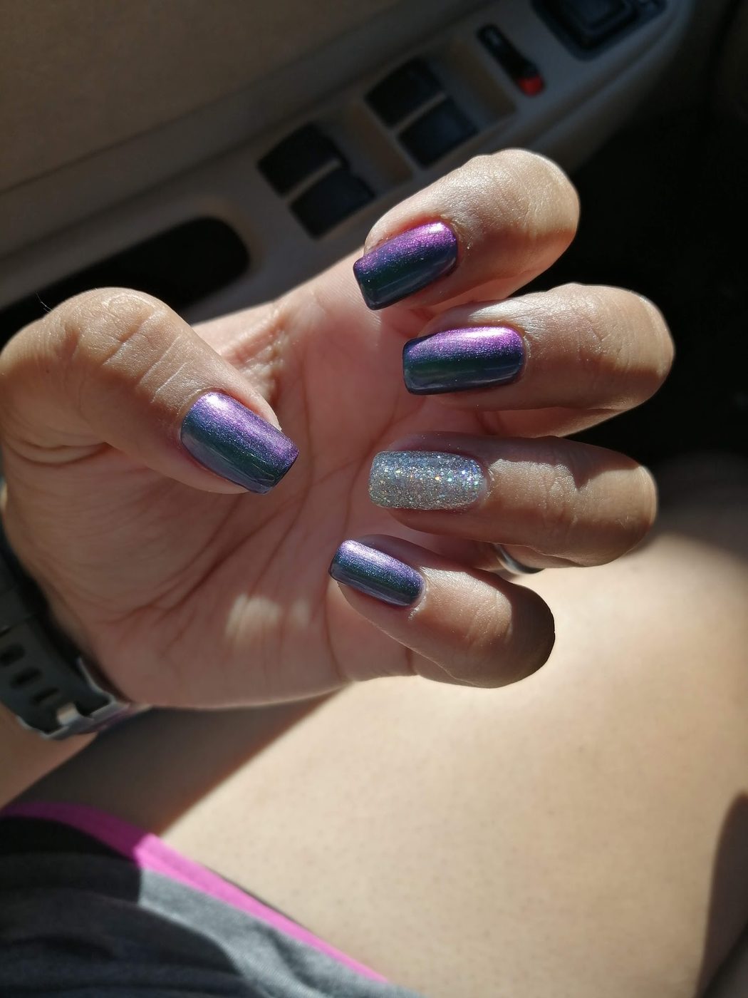Iridescent purple-teal manicure with a silver glitter accent nail.